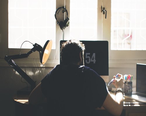 Person taking a break from laptop screen at a modern desk